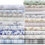 A stack of various flannel sheets with varying floral patterns.